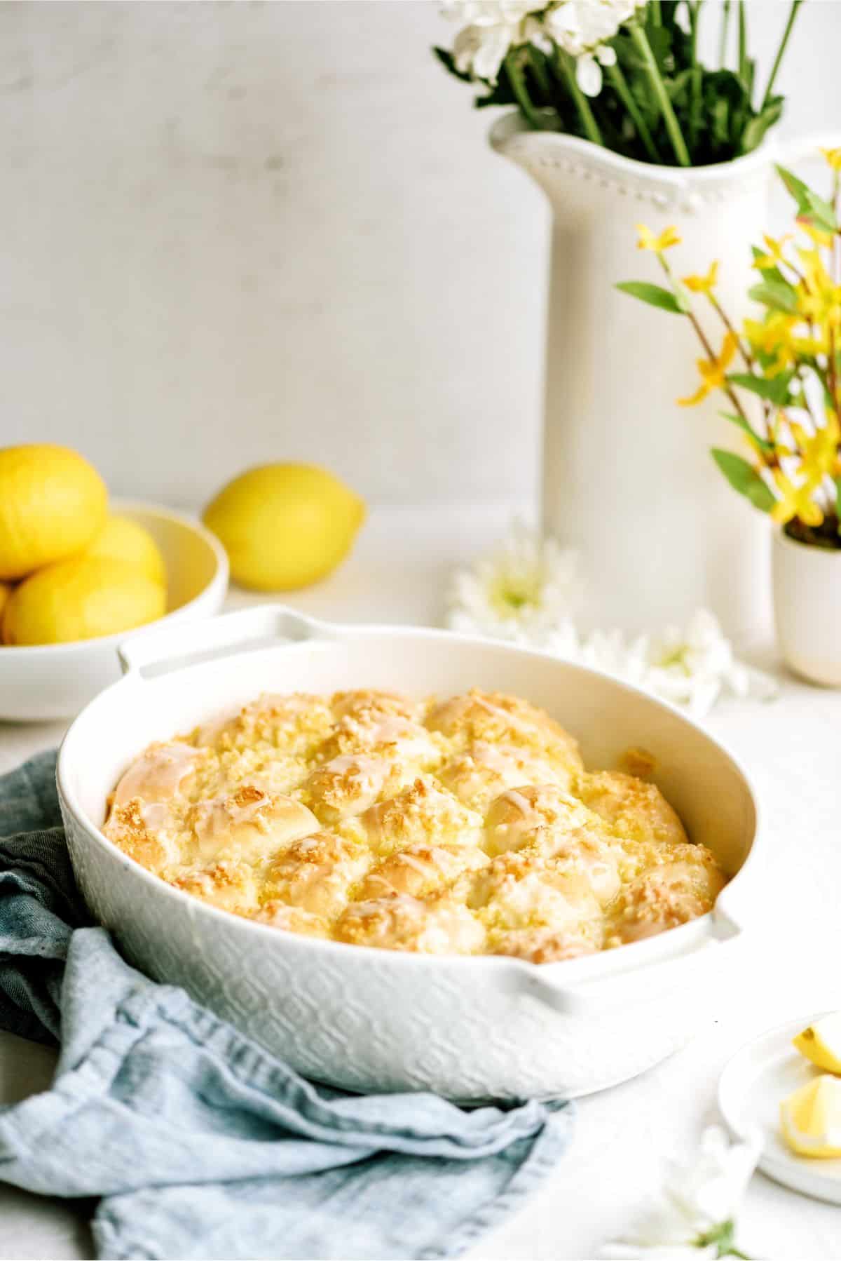 A pan of Easy Lemon Pull-Apart Rolls with lemons in the background