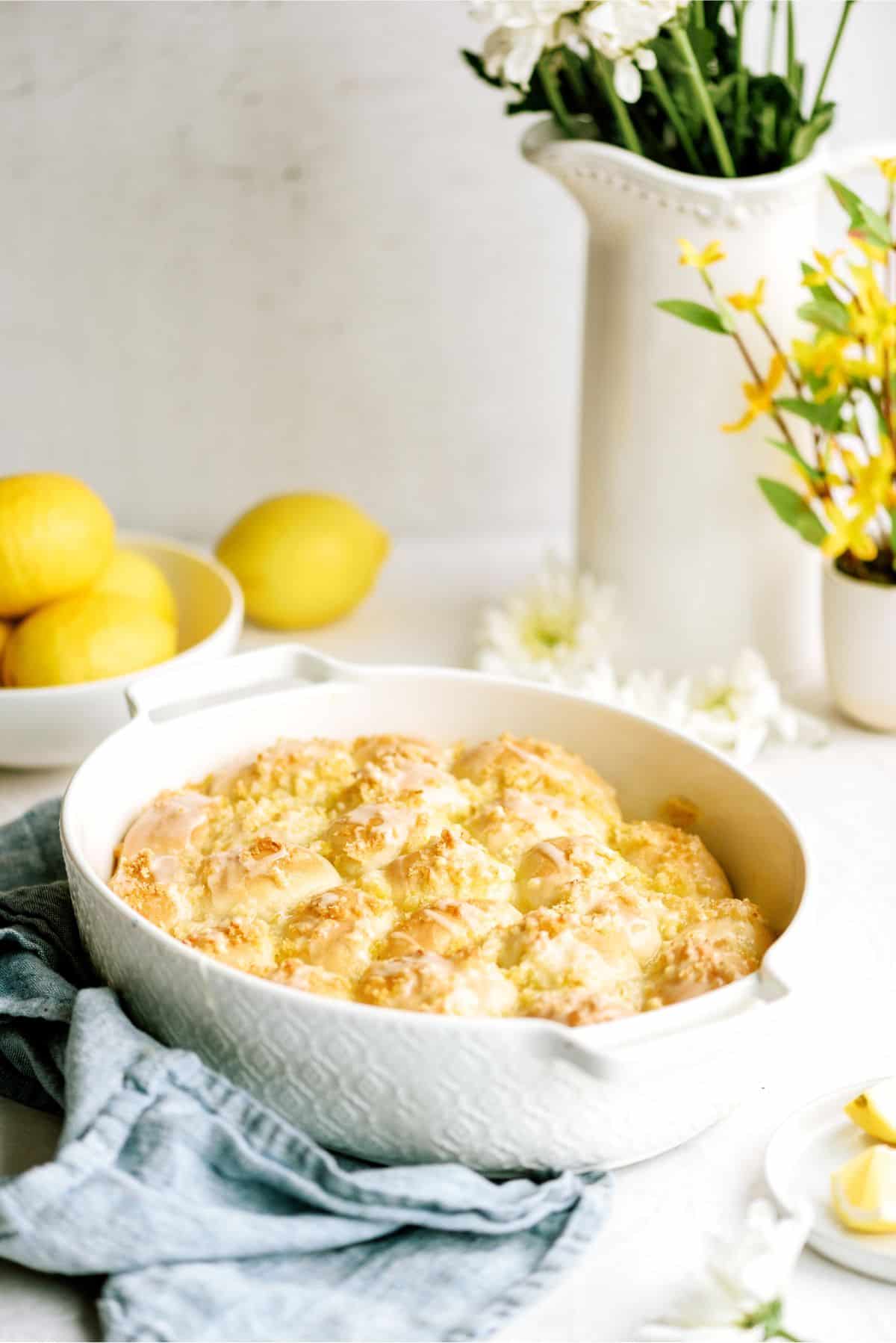 A pan of Easy Lemon Pull-Apart Rolls with lemons in the background