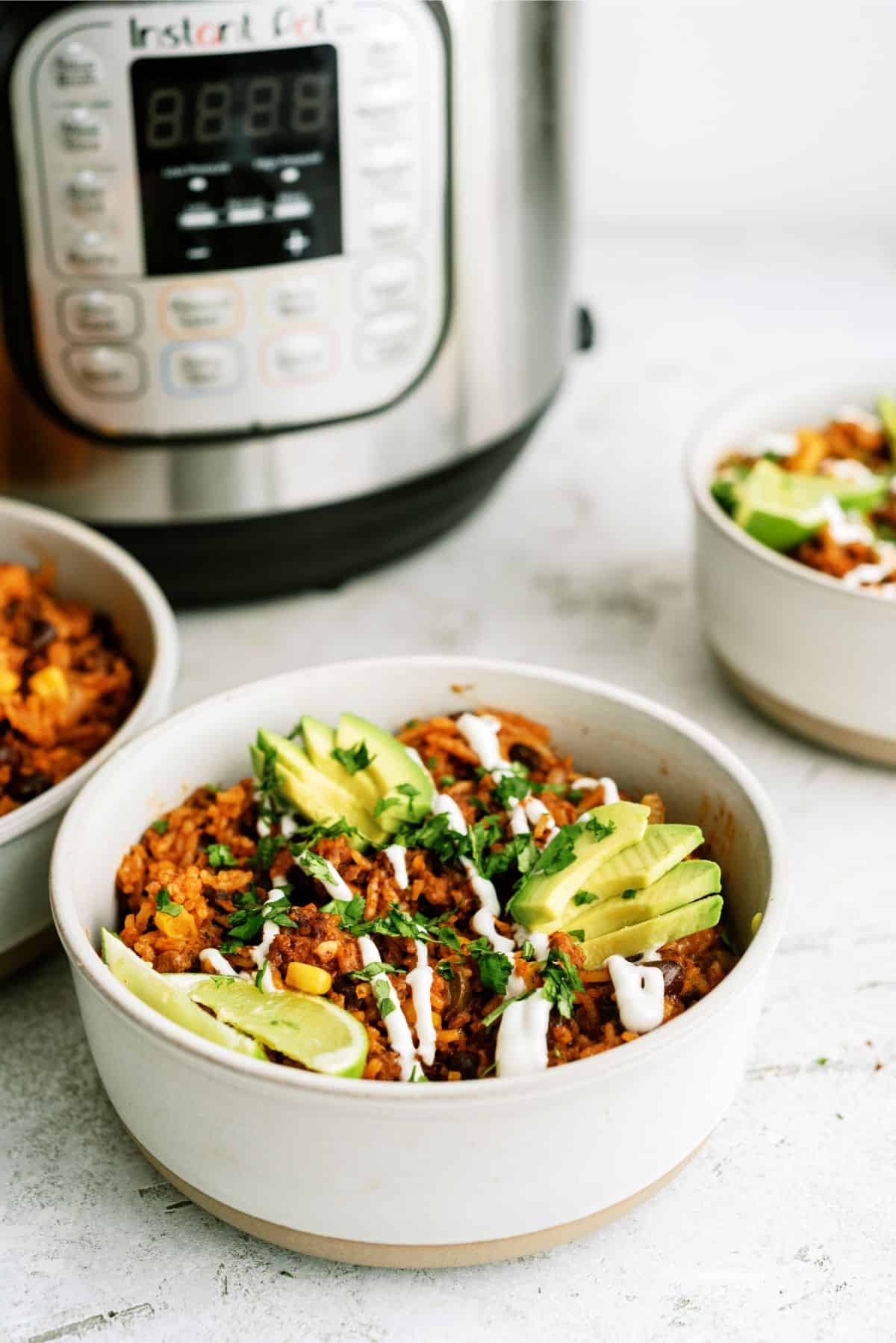 Instant Pot Ground Beef Burrito Bowls with an Instant pot in the background