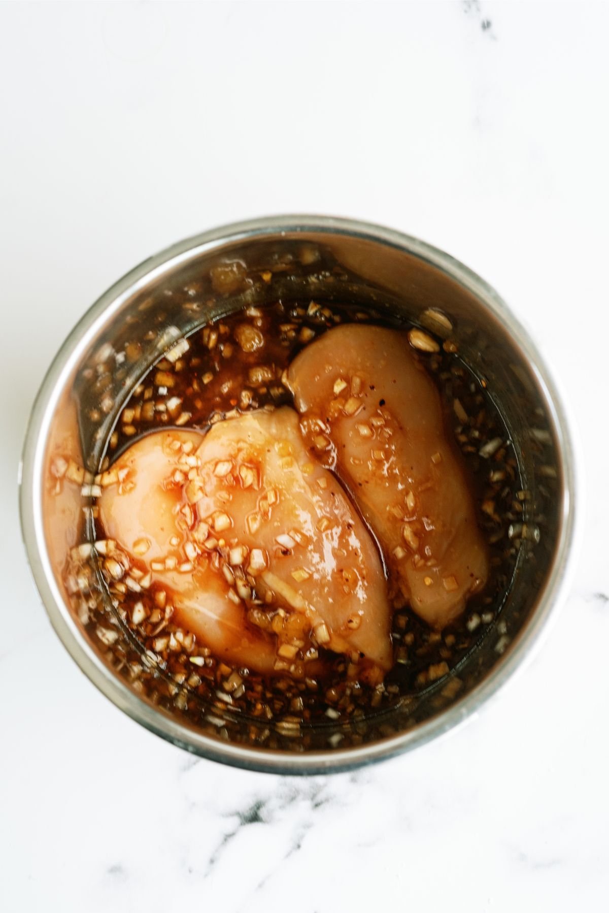 Chicken breast in the Instant Pot with sauce poured over the chicken