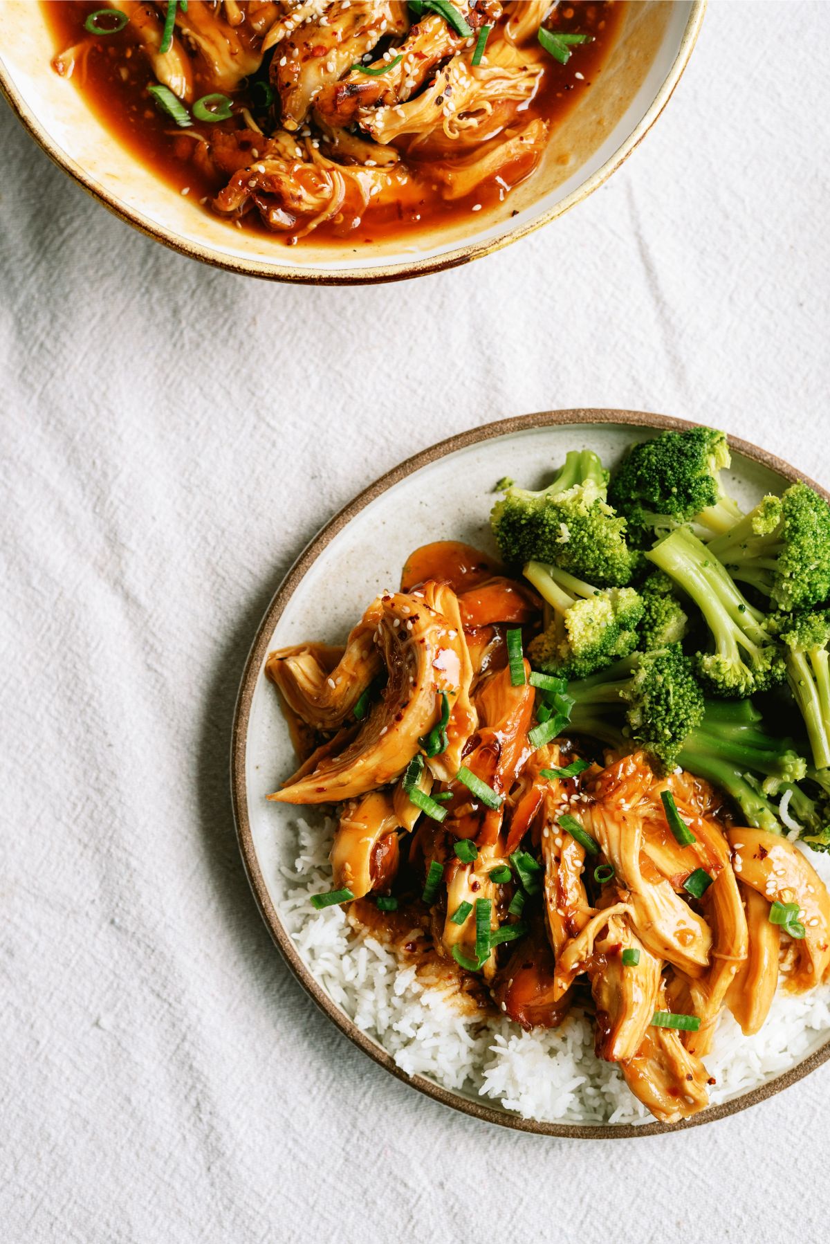 Instant Pot Honey Sesame Chicken on a plate with rice and broccoli