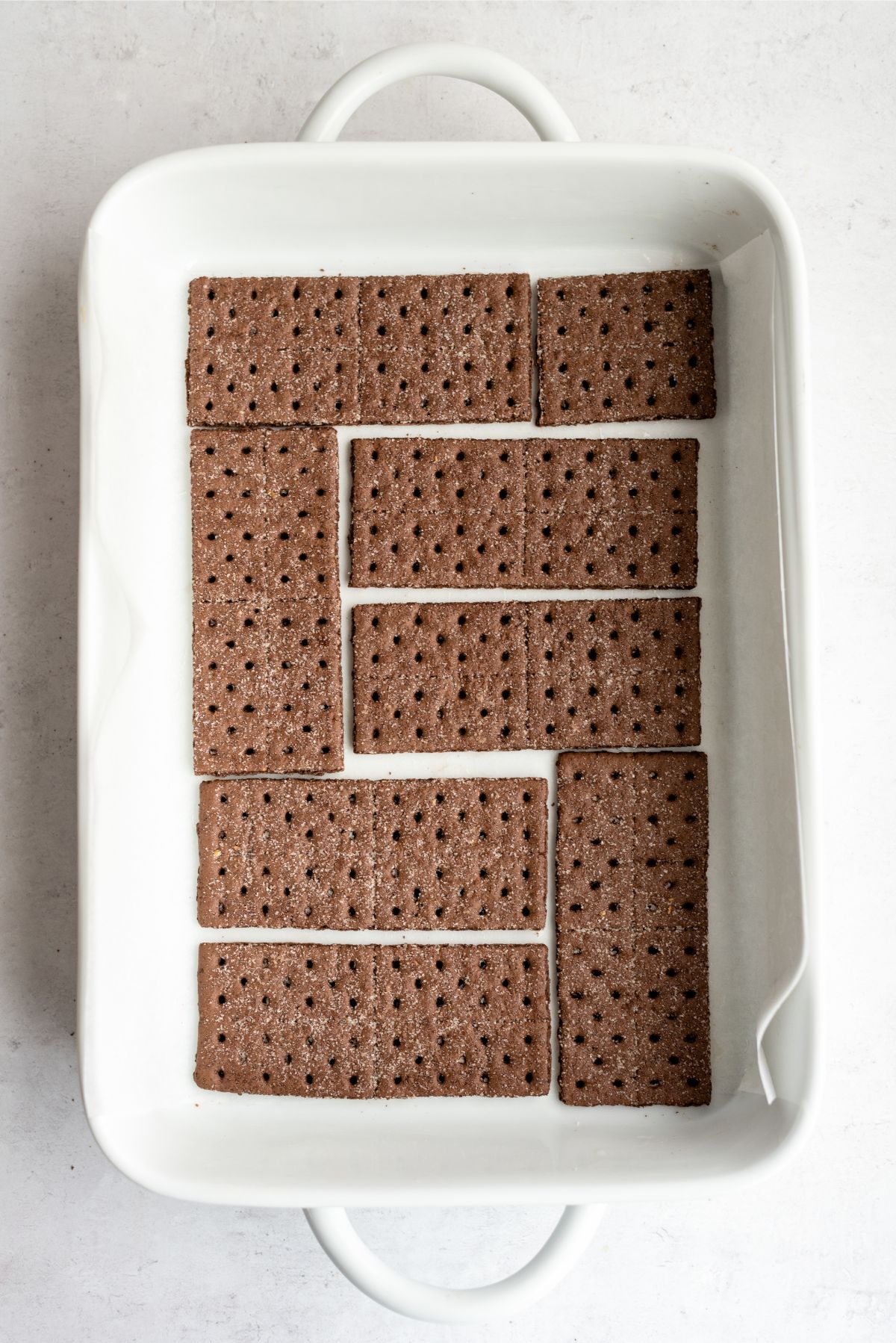 Chocolate graham crackers on the bottom of a 9x13 pan