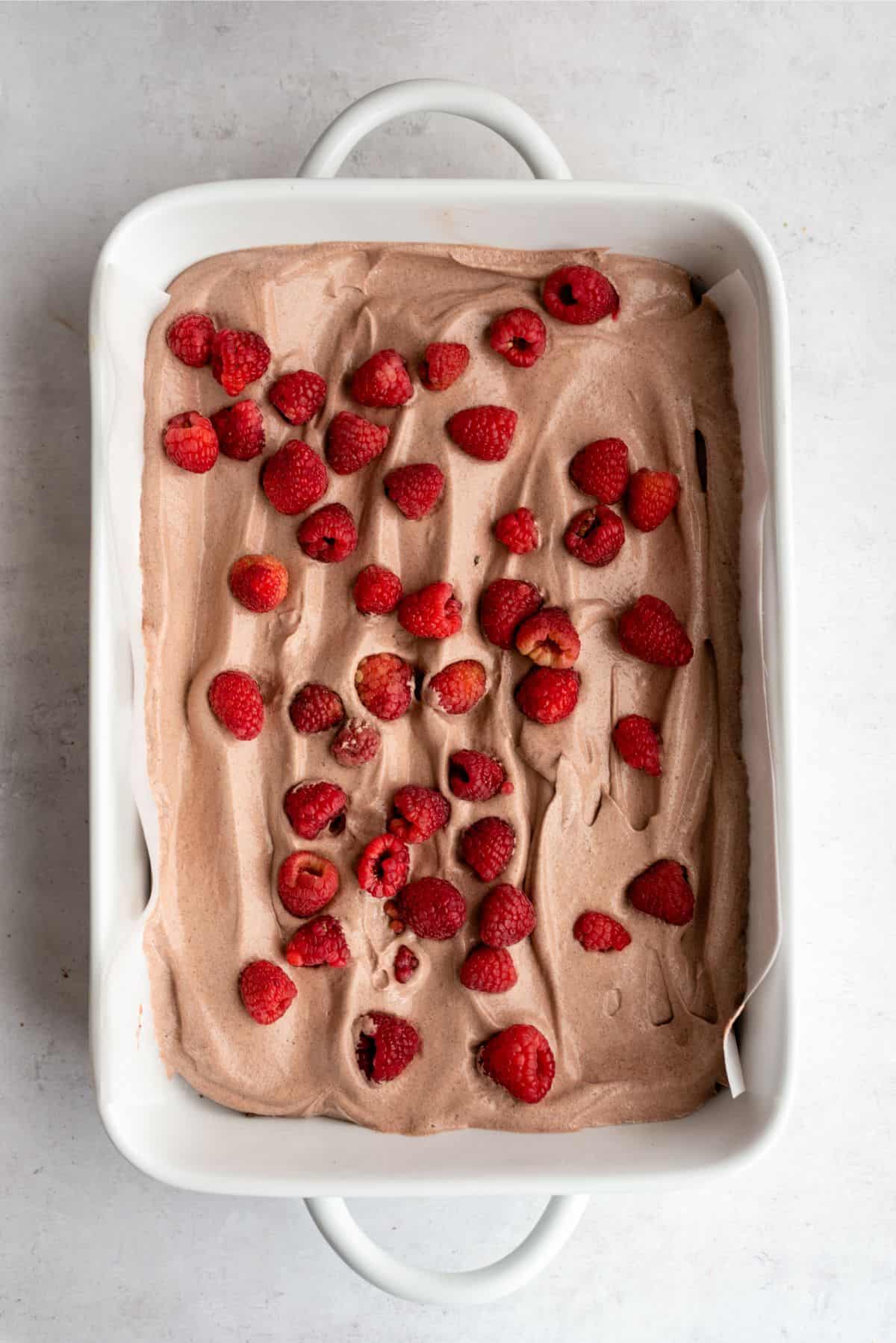 Pudding layer on top of graham crackers topped with raspberries