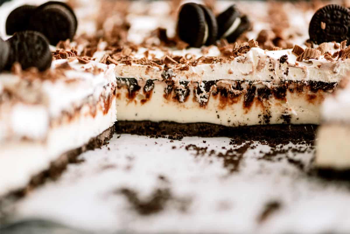 Oreo Ice Cream Cake Dessert cut into squares in baking dish.