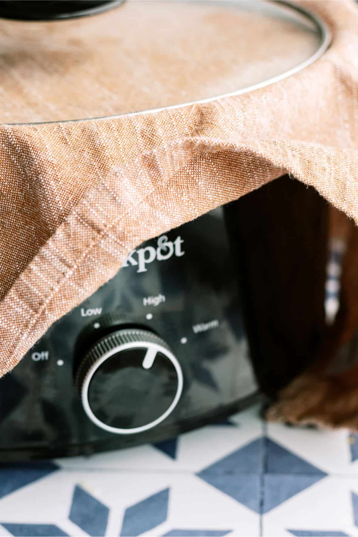 Towel under lid and on top of slow cooker