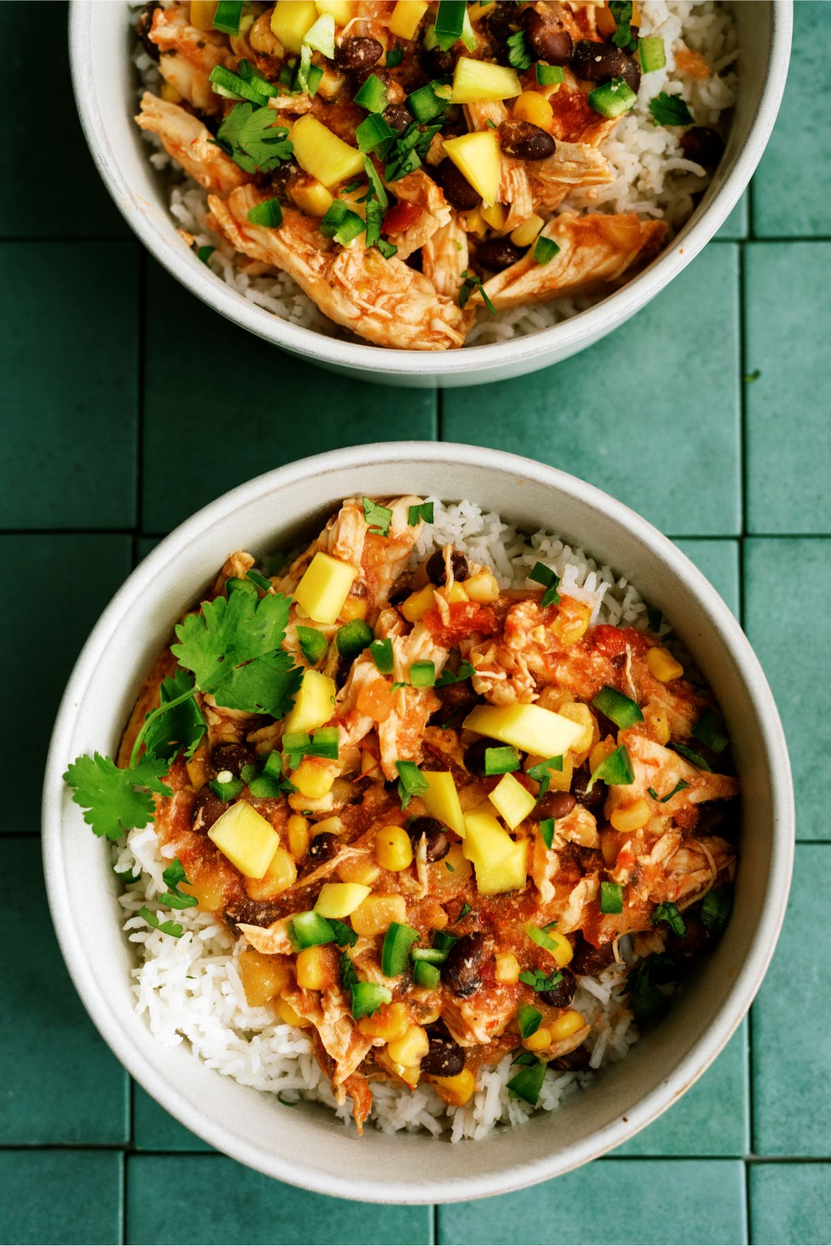 Slow Cooker Mango Chicken in two bowls on top of rice