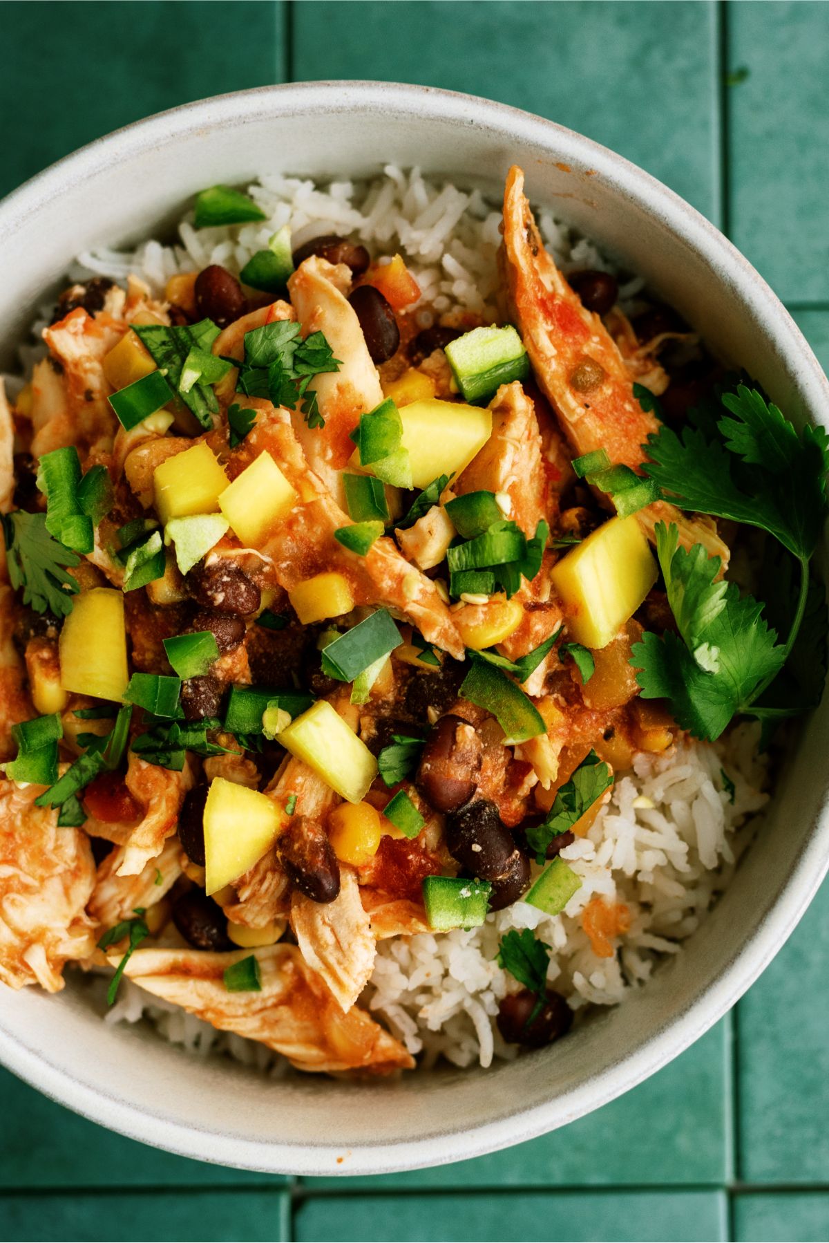 Close up of Slow Cooker Mango Chicken in a bowl on top of rice