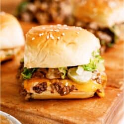 Big Mac Sliders on a cutting board with sauce.