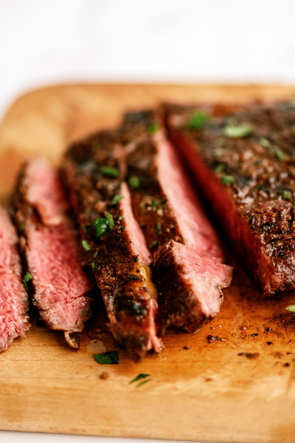 Grilled Ribeye Steak sliced into strips on cutting board