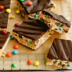 Monster Cookie No Bake Bars cut into squares and surrounded by mini M&M's.
