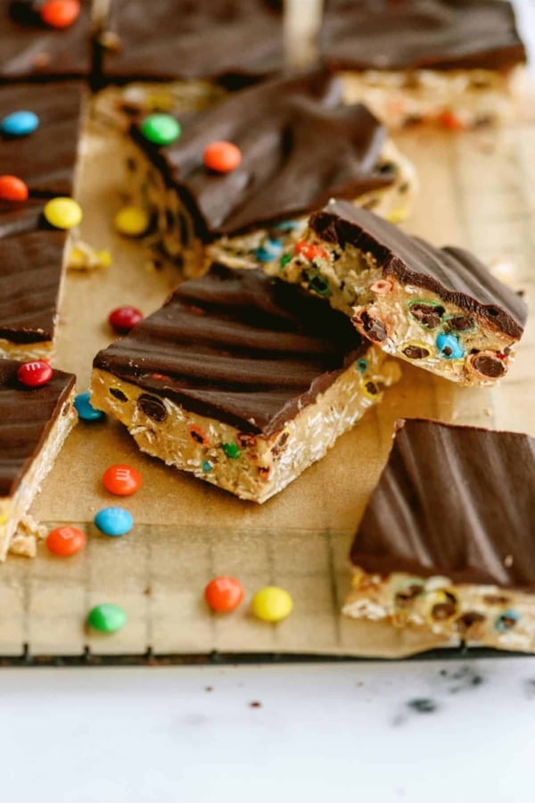 Monster Cookie No Bake Bars cut into squares and surrounded by mini M&M's.