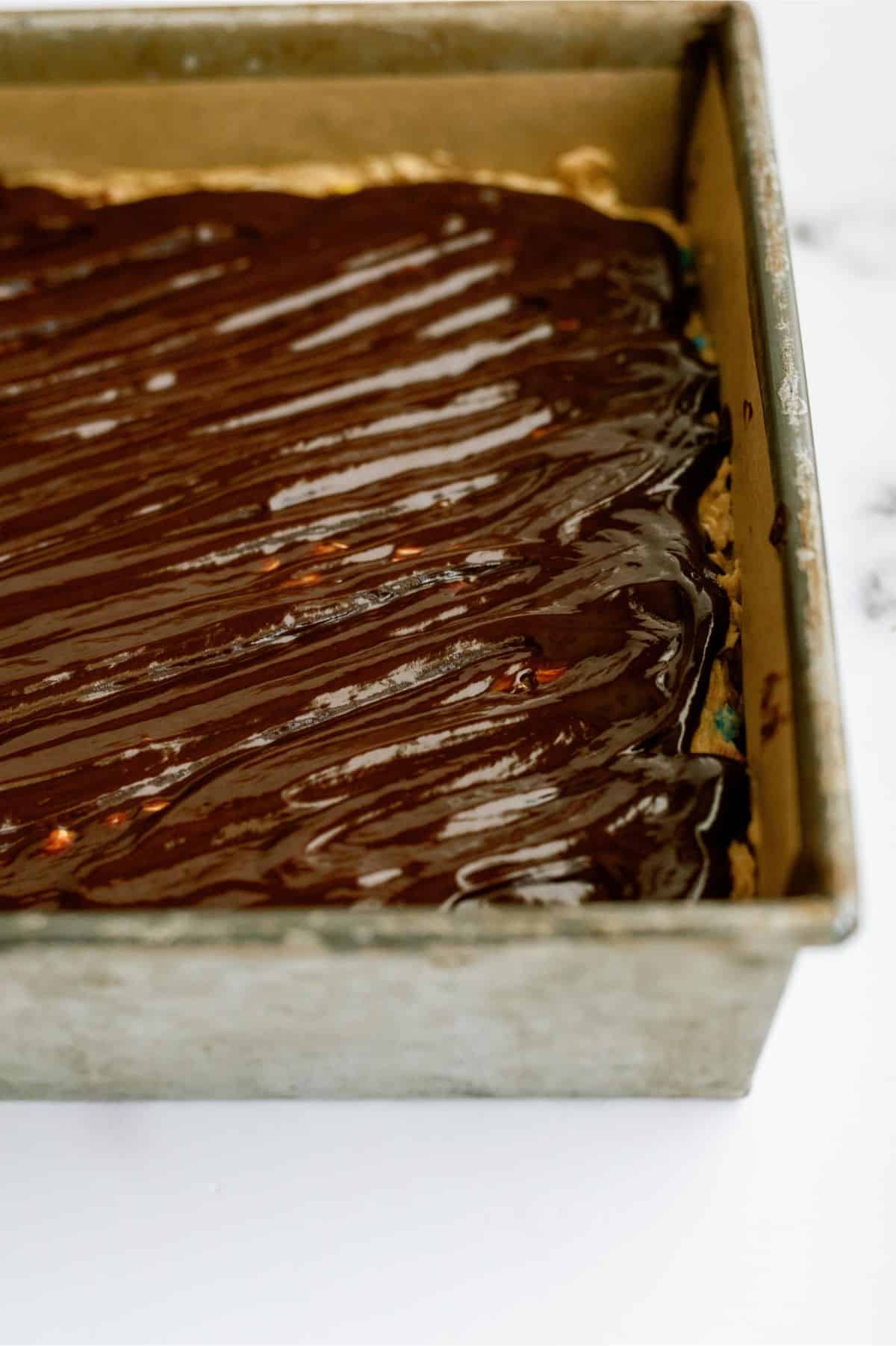 Monster Cookie No Bake Bars topped with chocolate ganache.