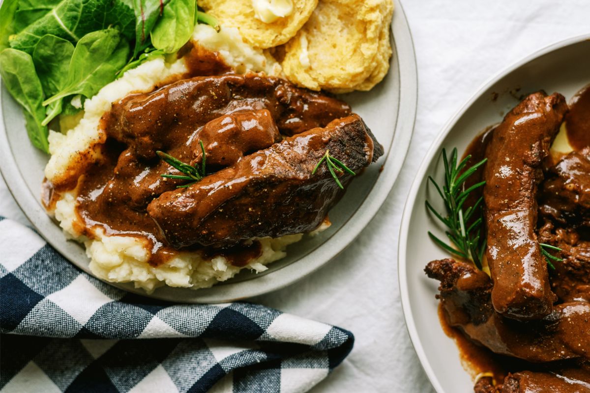 Close up of Slow Cooker Mississippi-Style Country Ribs served over Mashed Potatoes on a plate