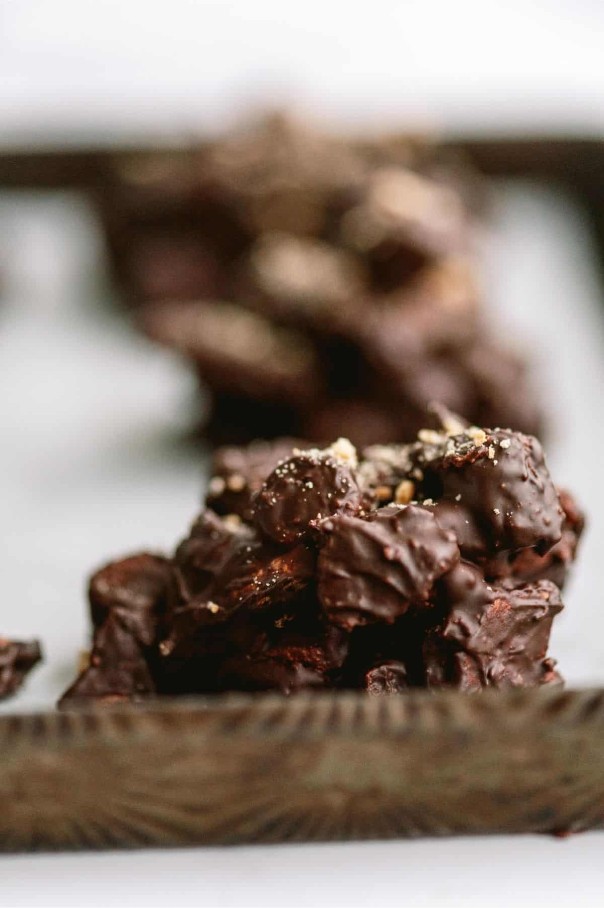 Side view of a S’mores Cluster on a baking sheet with other S’mores Clusters in the background.