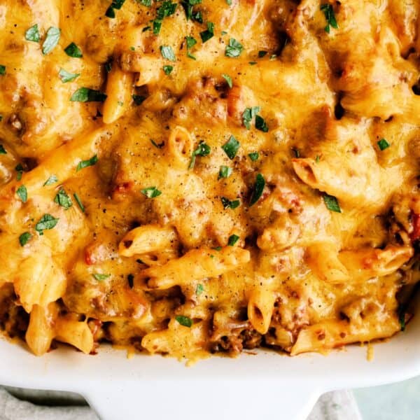 Close-up of cheesy cheeseburger casserole with herbs and ground beef.
