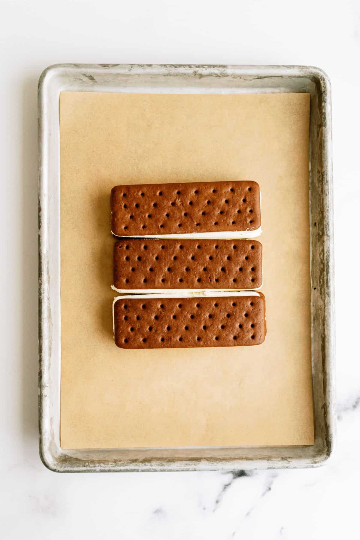 3 Ice cream sandwiches lined up on a pan