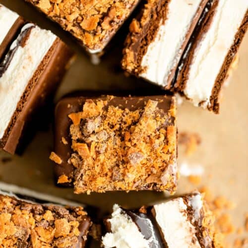 Slices of Ice Cream Cake cut into squares with some pieces tipped on the side.