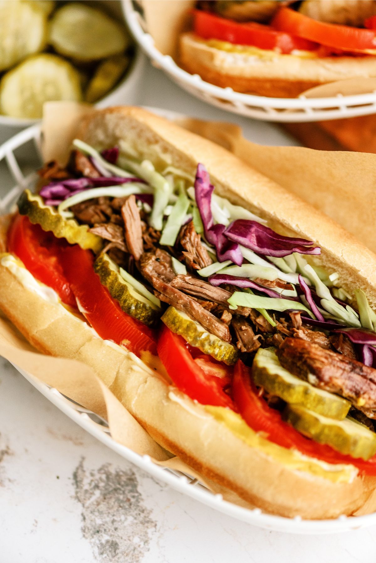 Close up of Instant Pot Beef Po Boy Sandwiches with toppings