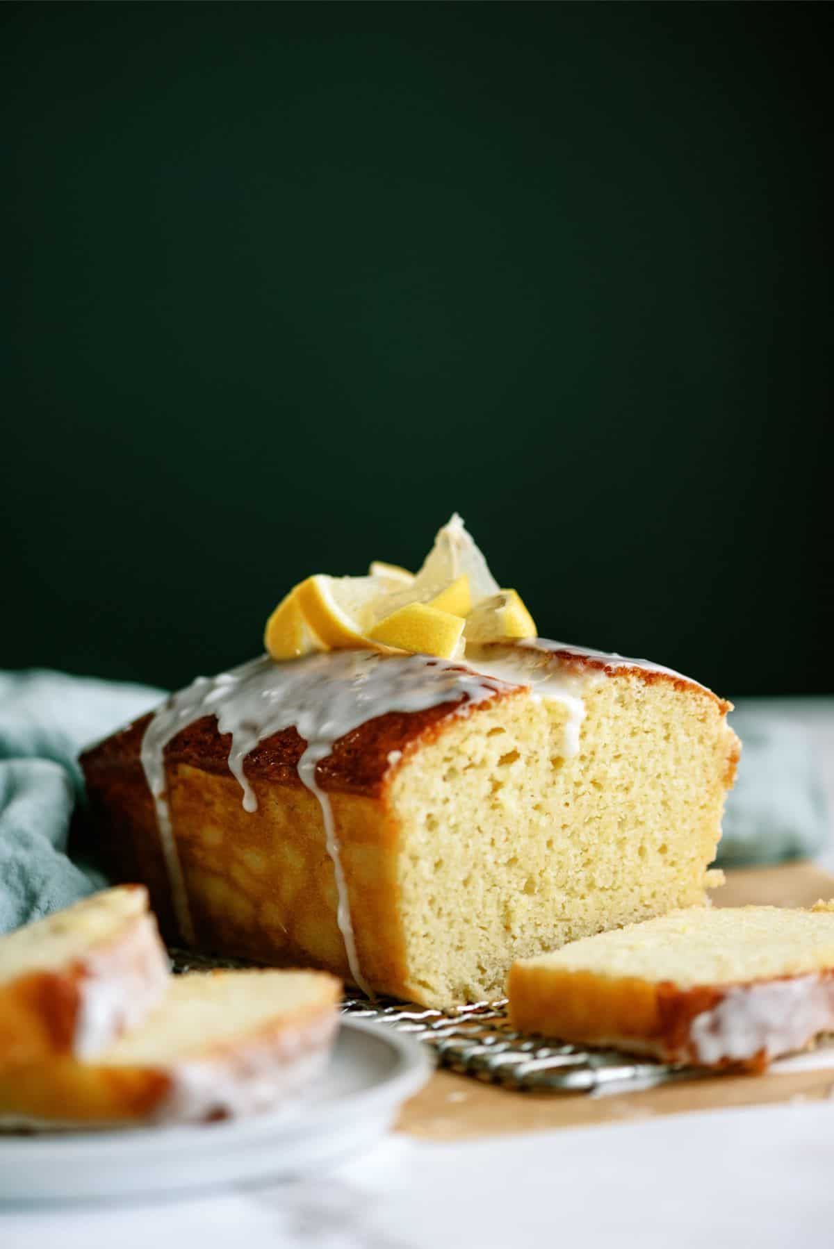 A loaf of Lemon Yogurt Bread with fresh lemons