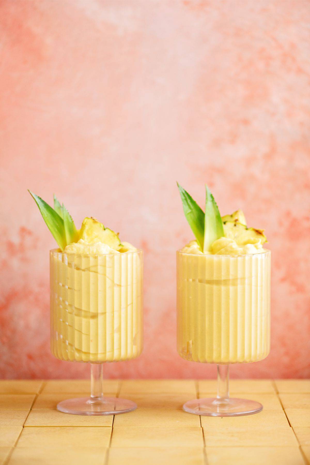 2 glasses of Mango and Pineapple Dole Whips topped with pineapple