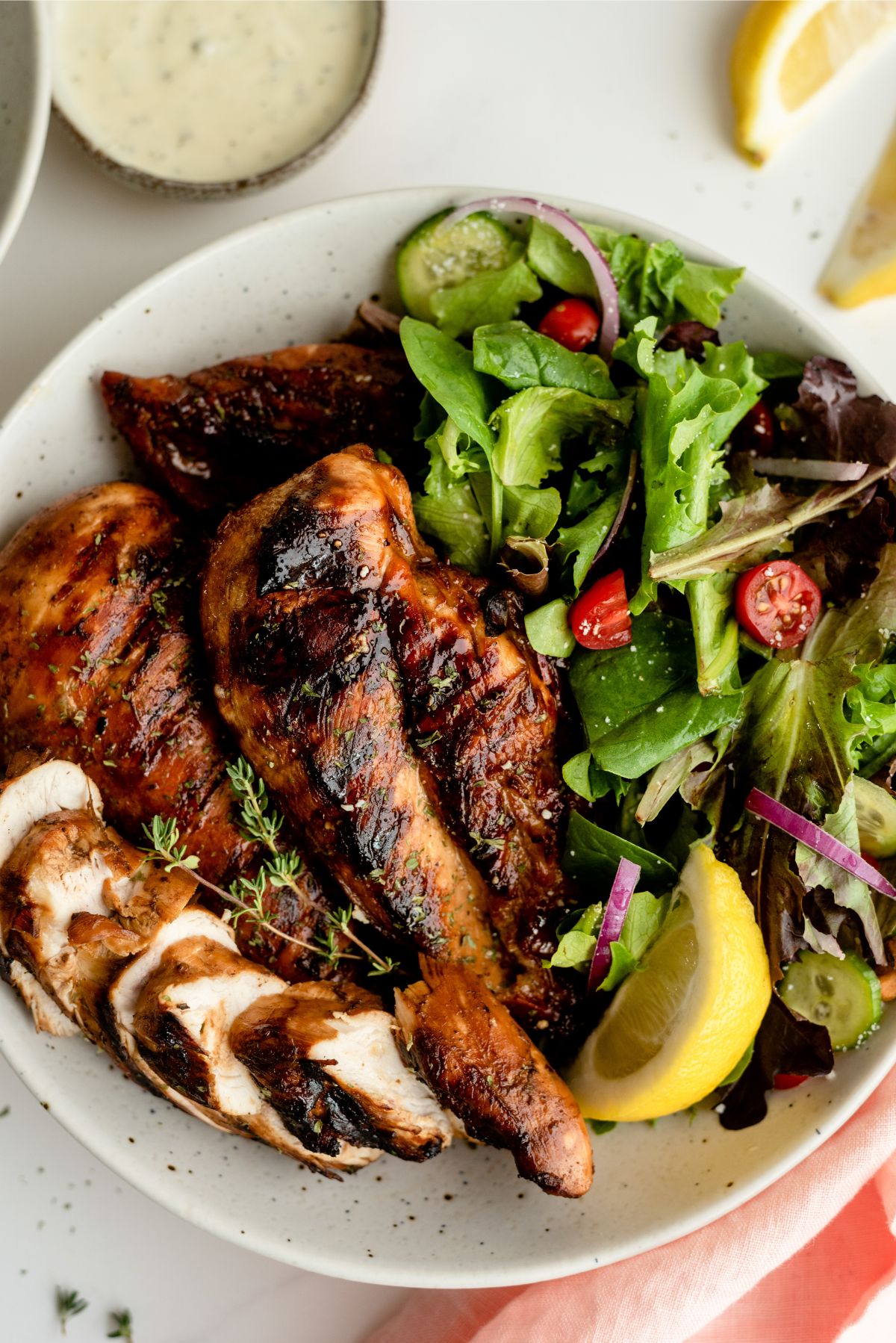 Marinated Root Beer Grilled Chicken on a plate with salad