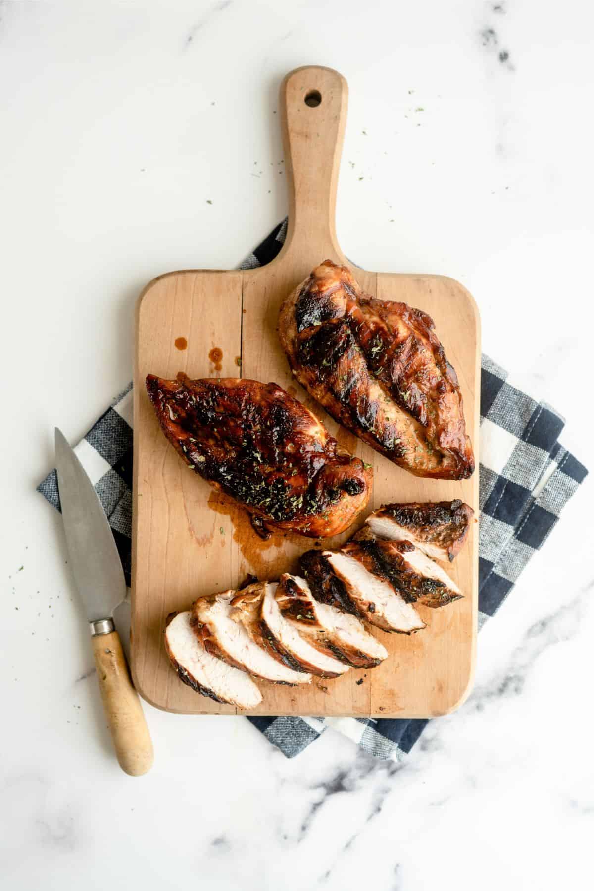 Marinated Root Beer Grilled Chicken on a cutting board sliced