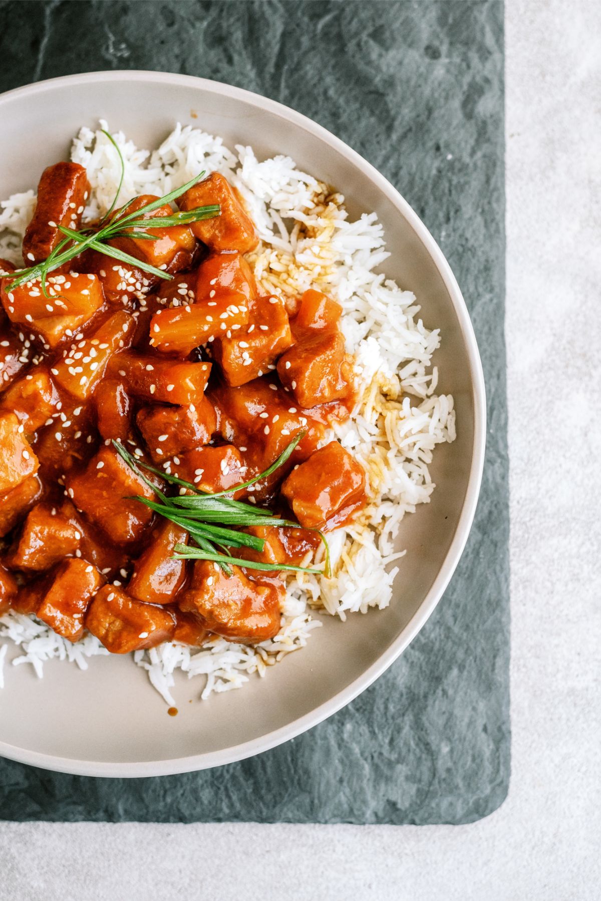 Slow Cooker Sweet and Tangy Pork served on top of rice
