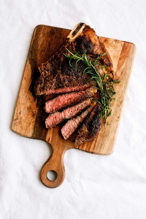 steak slices on wood cutting board