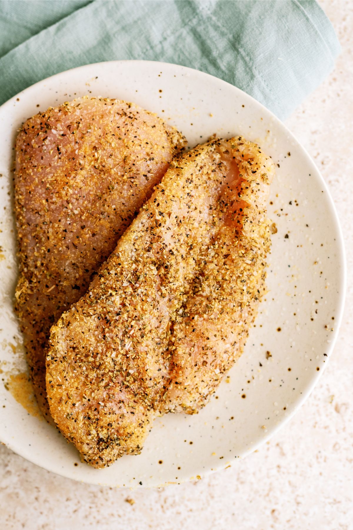 Seasoned raw chicken breast ready for the air fryer