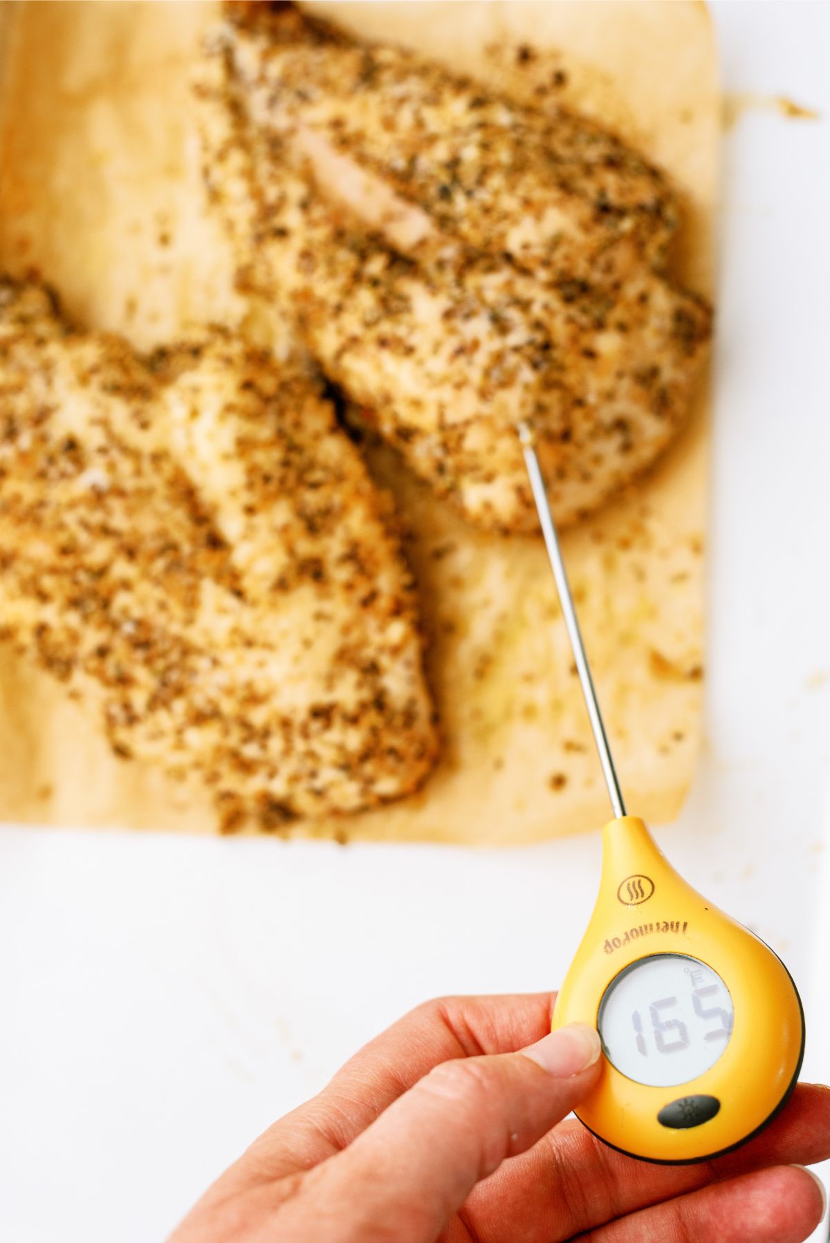 Air Fryer Chicken Breasts cooked with a meat thermometer showing 165 temp