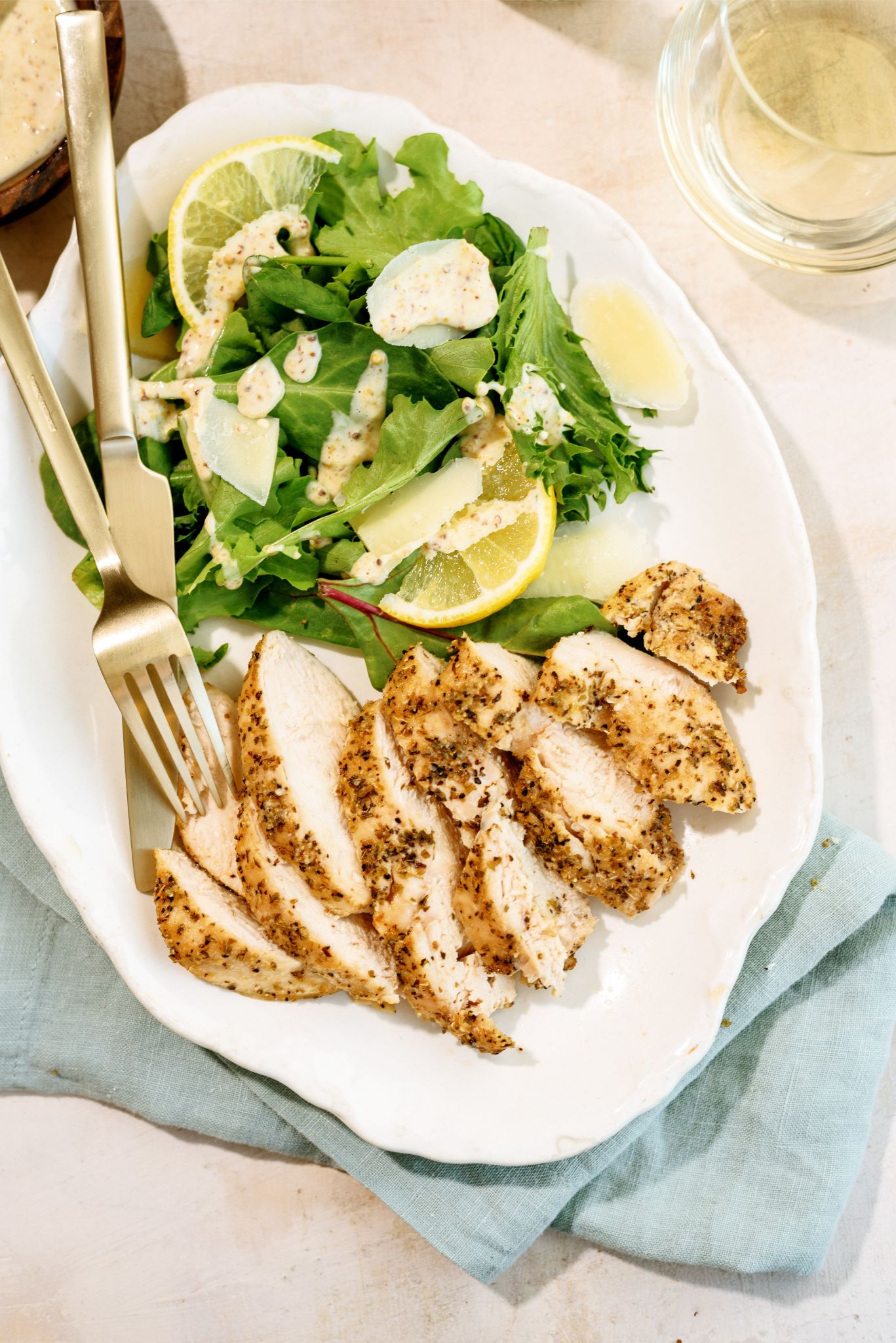 Air Fryer Chicken Breasts slice on a plate with a salad