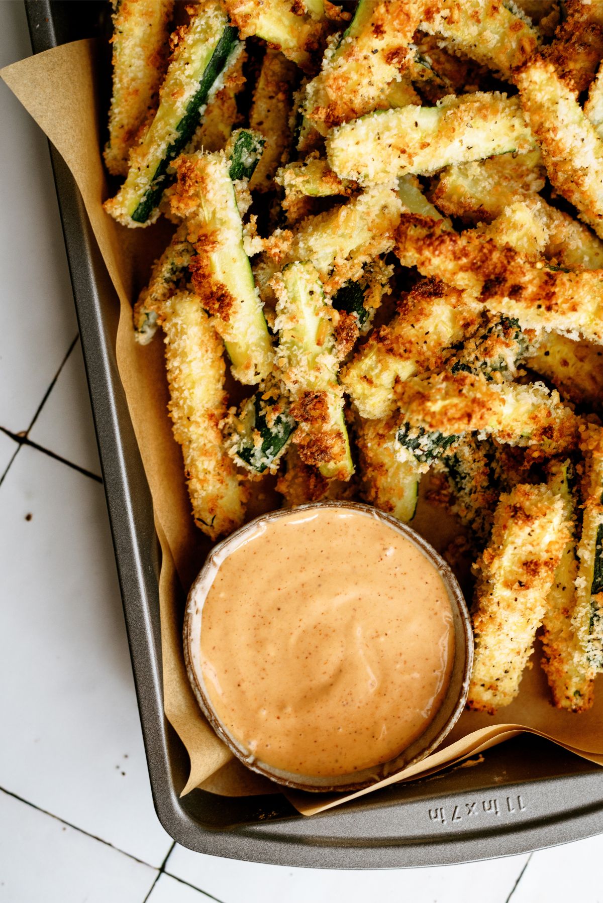 Crispy Zucchini Fries in a basket with a side of Creamy BBQ Sauce