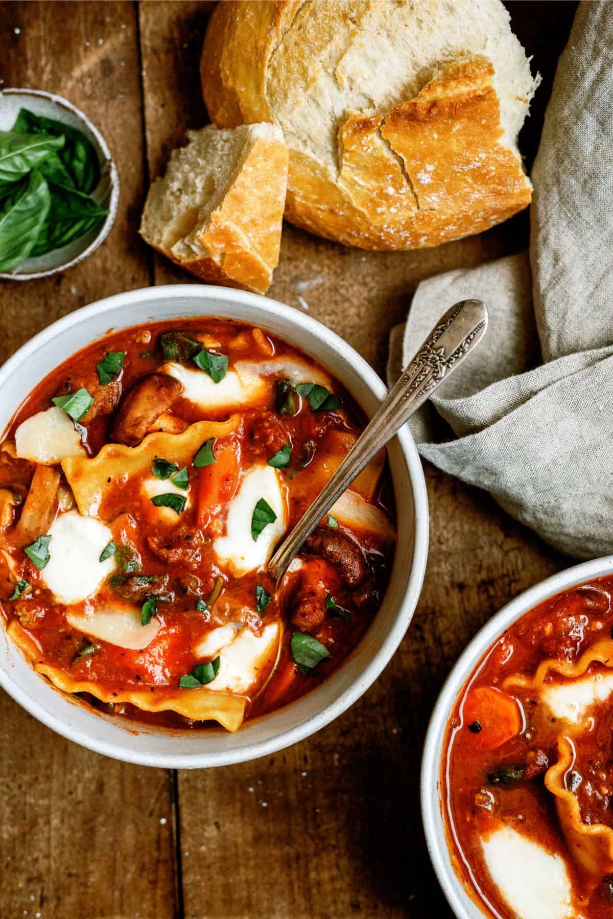 A bowl of Instant Pot Lasagna Soup with crusty bread on the side