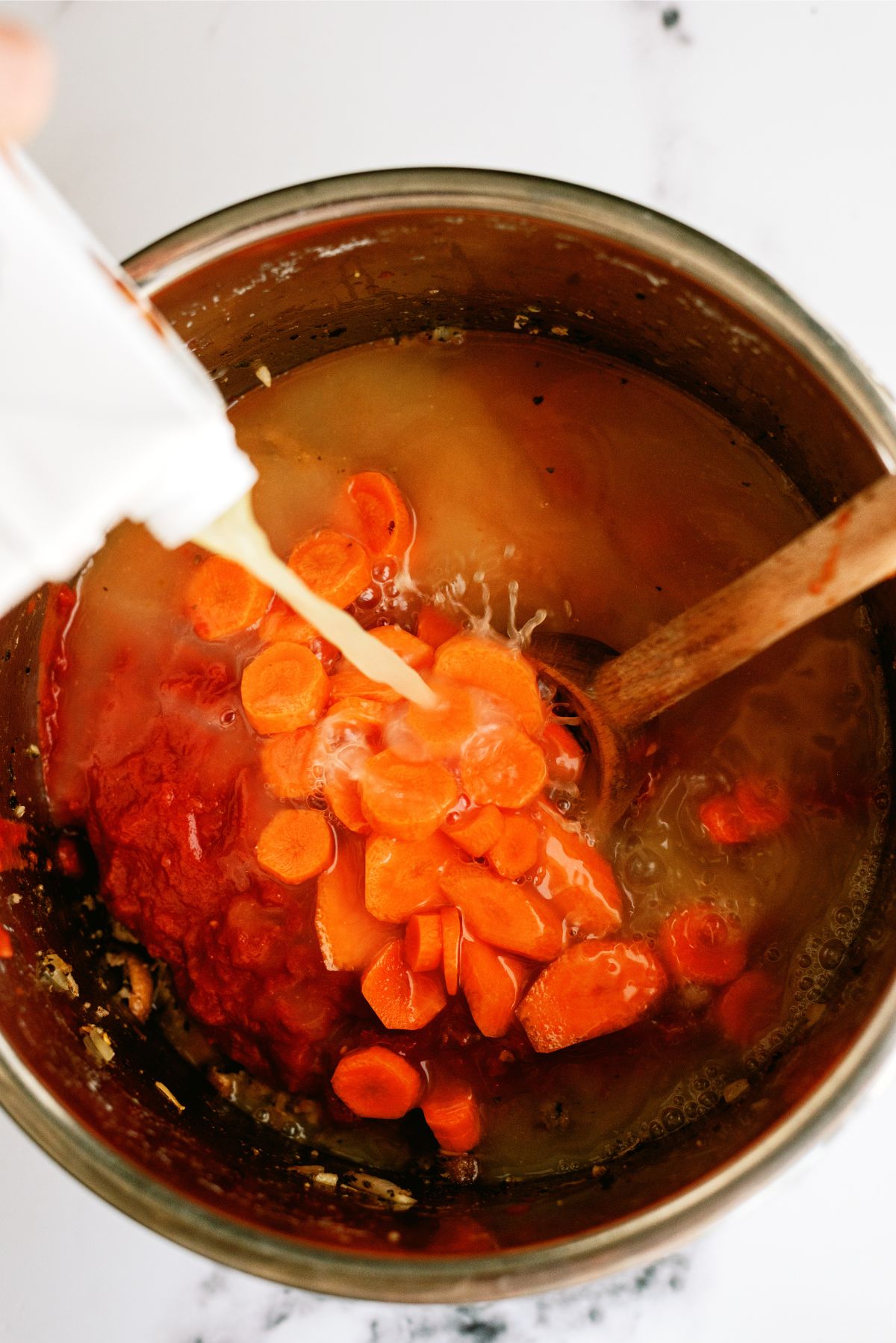 Tomatoes, carrots and broth added to Instant Pot