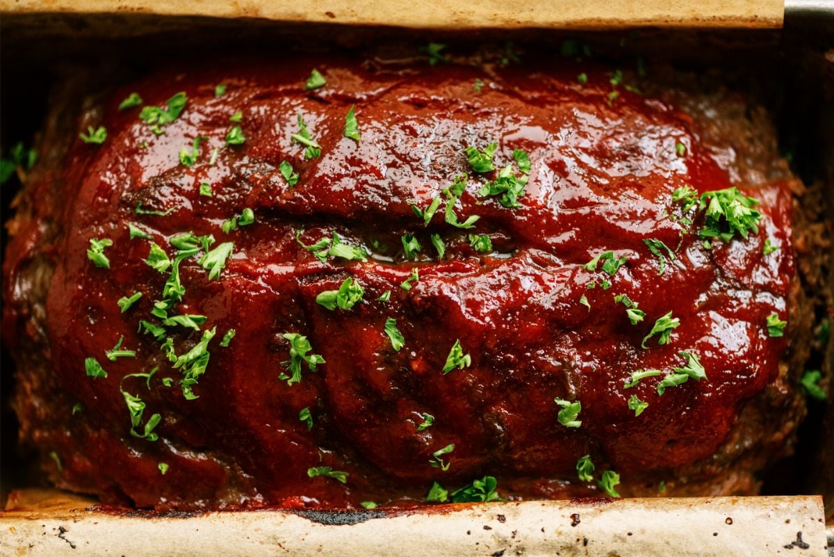 Meatloaf cooked in loaf pan with glaze on top