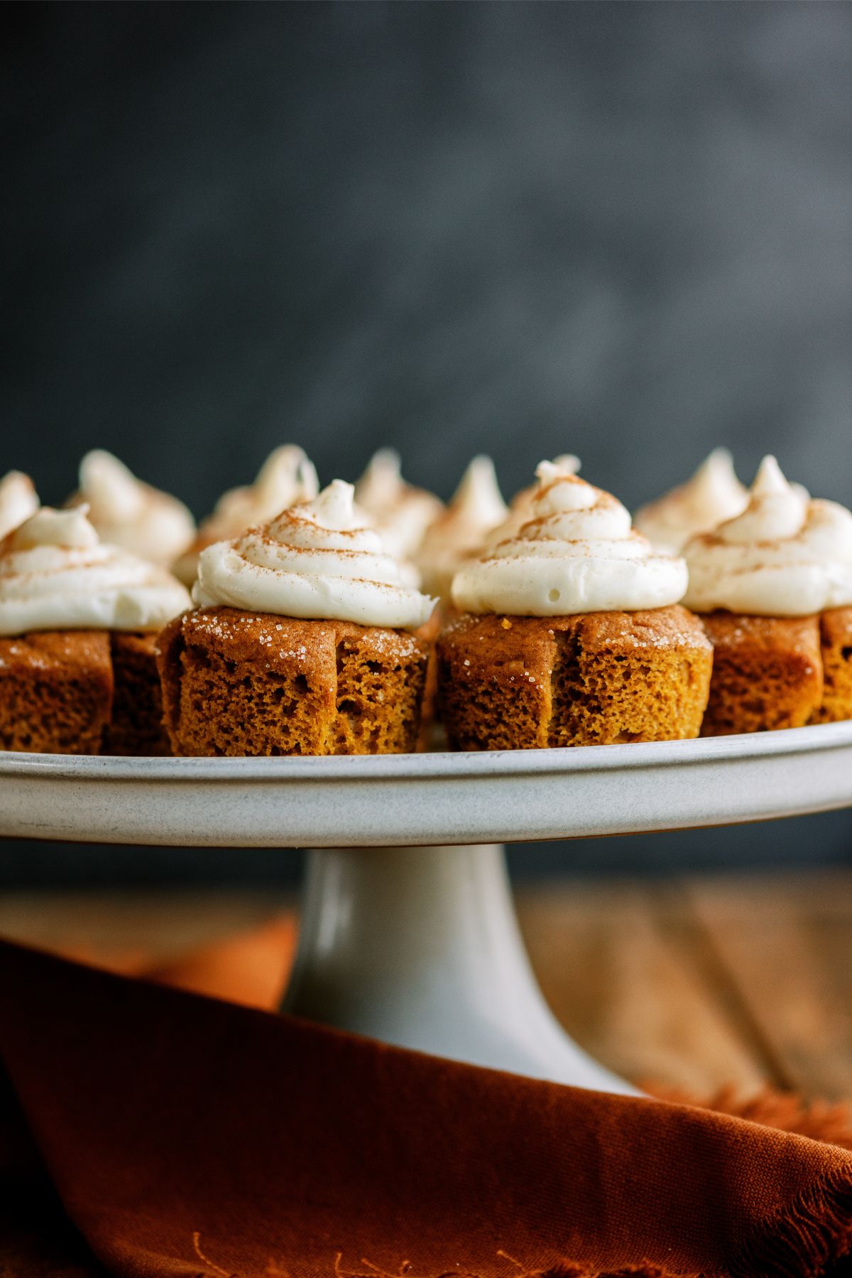 Pumpkin Cupcakes with cream cheese frosting on cake stand