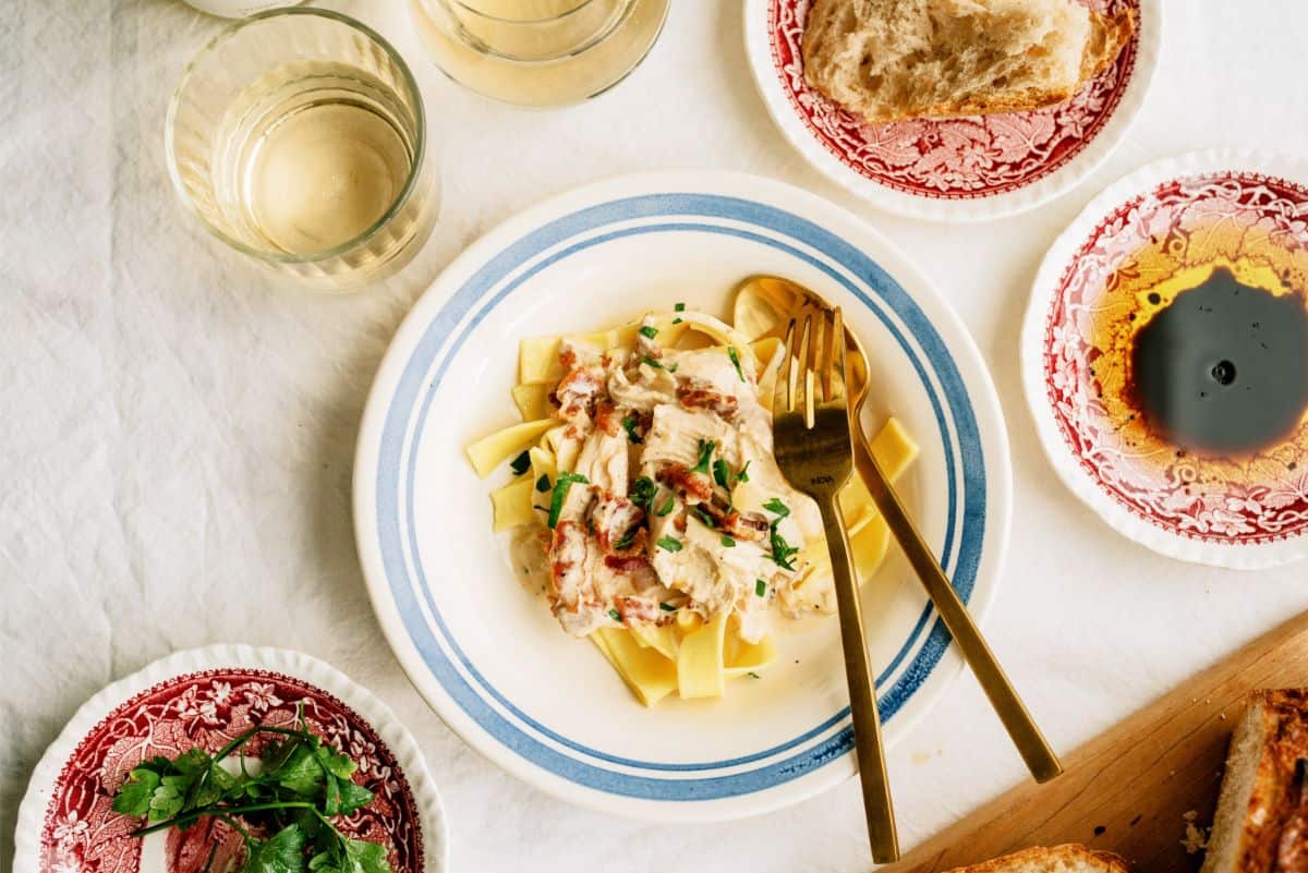 Slow Cooker Creamy Bacon Chicken served over egg noodles in a bowl