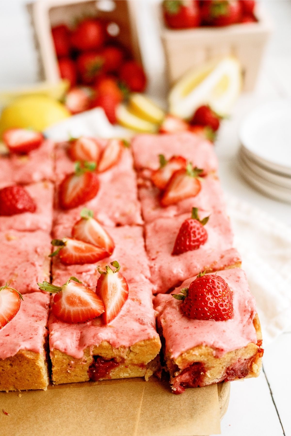 Strawberry Lemon Blondies Bars cut into squares topped with sliced strawberrries