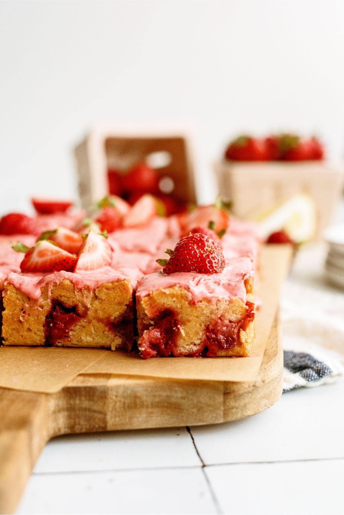 Strawberry Lemon Blondies Bars cut into squares topped with sliced strawberries