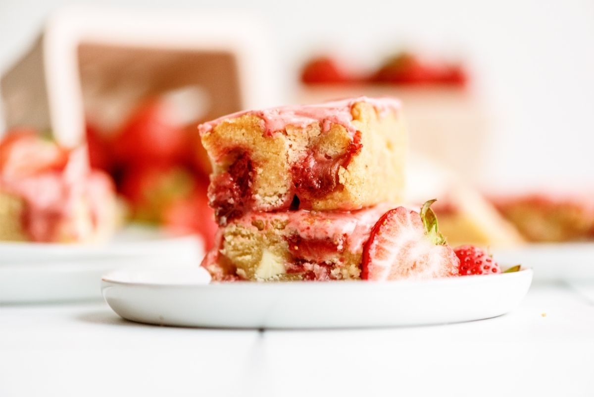 2 Strawberry Lemon Blondies Bars stacked on top of each other on a plate
