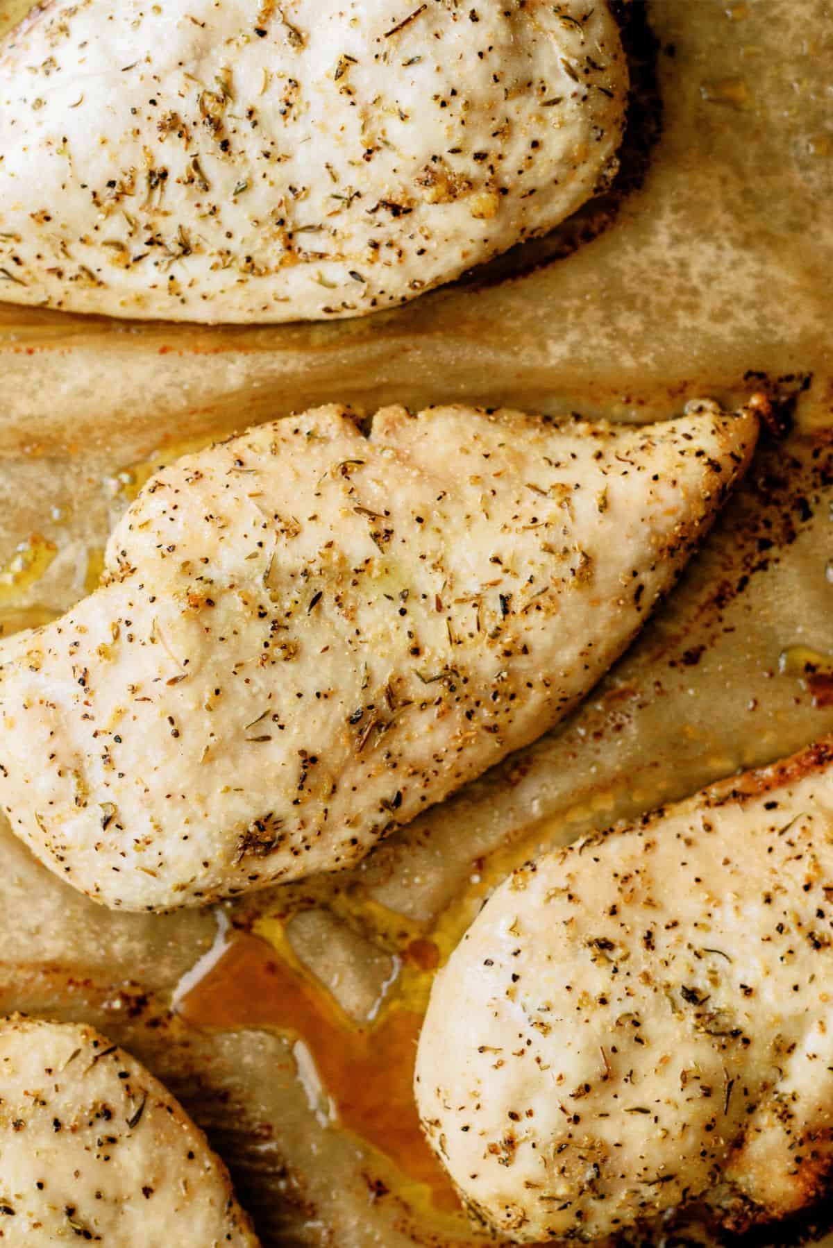Baked Chicken Breast on a baking sheet lined with parchment paper.