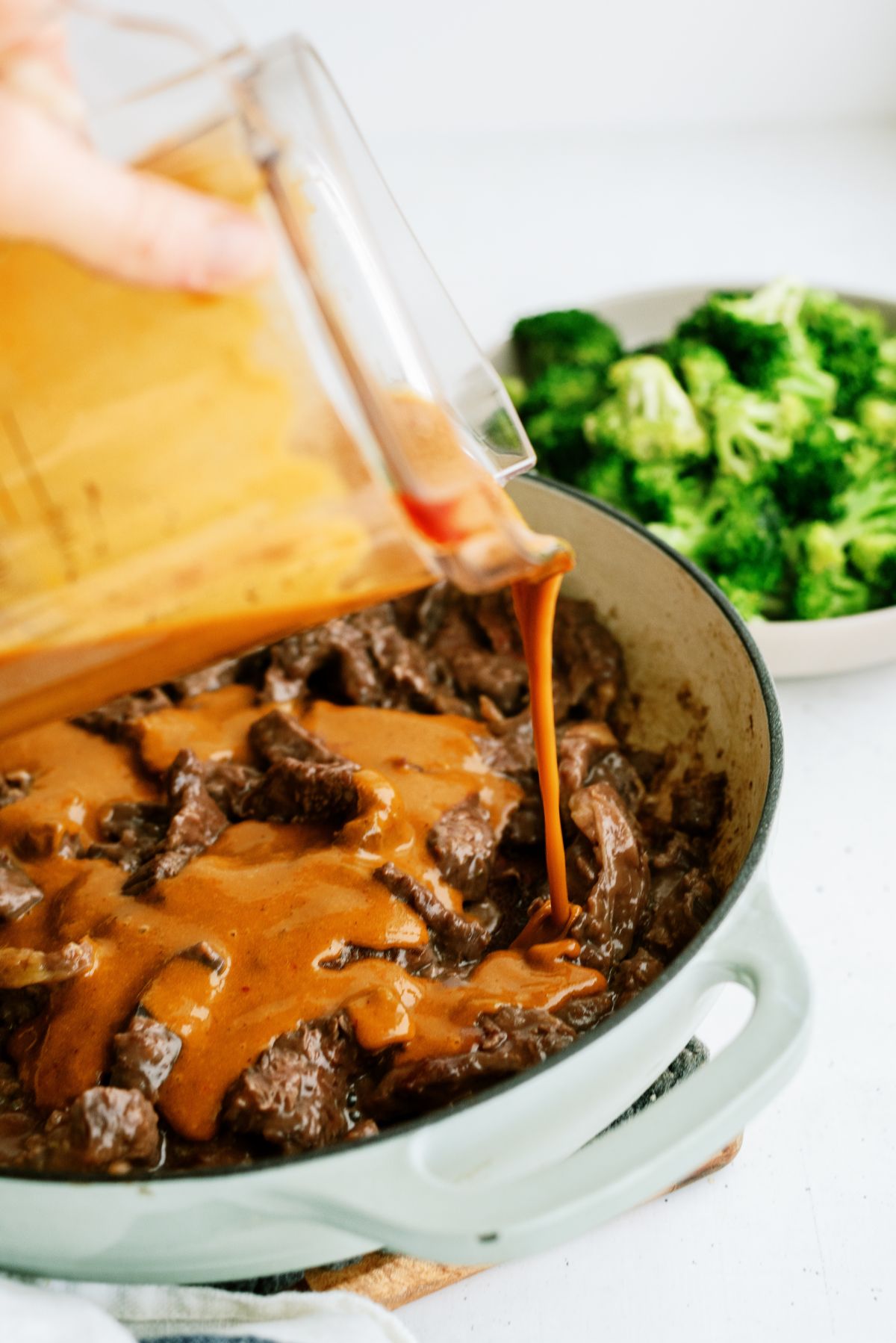 Adding Beef and Broccoli sauce to skillet