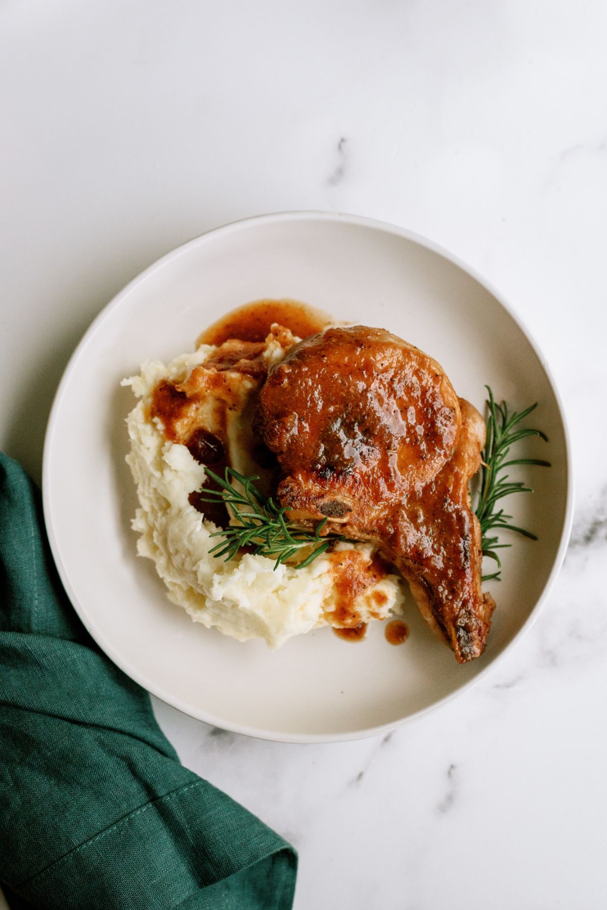 Instant Pot Cranberry Pork Chop on top of mashed potatoes