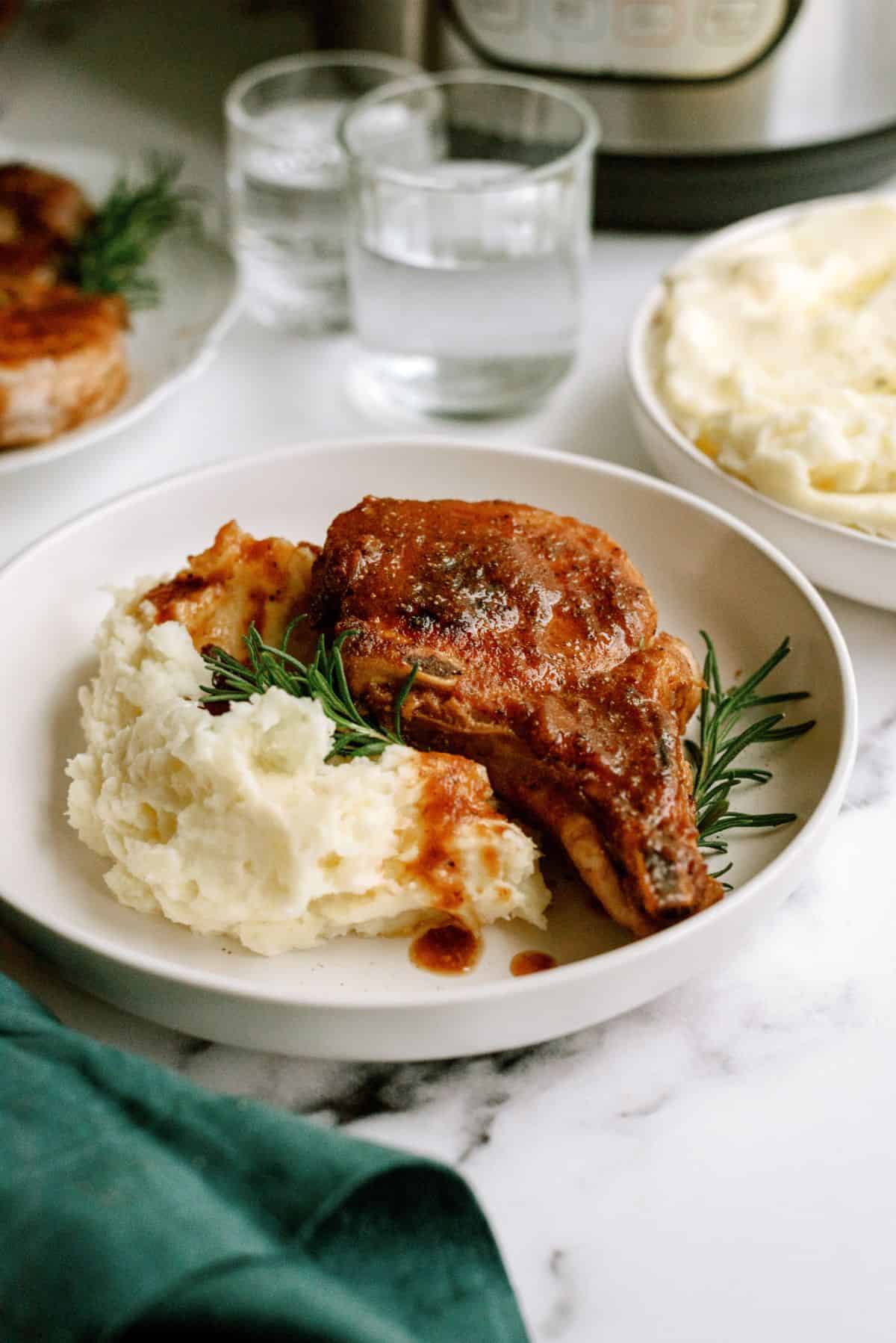 Instant Pot Cranberry Pork Chops served over mashed potatoes