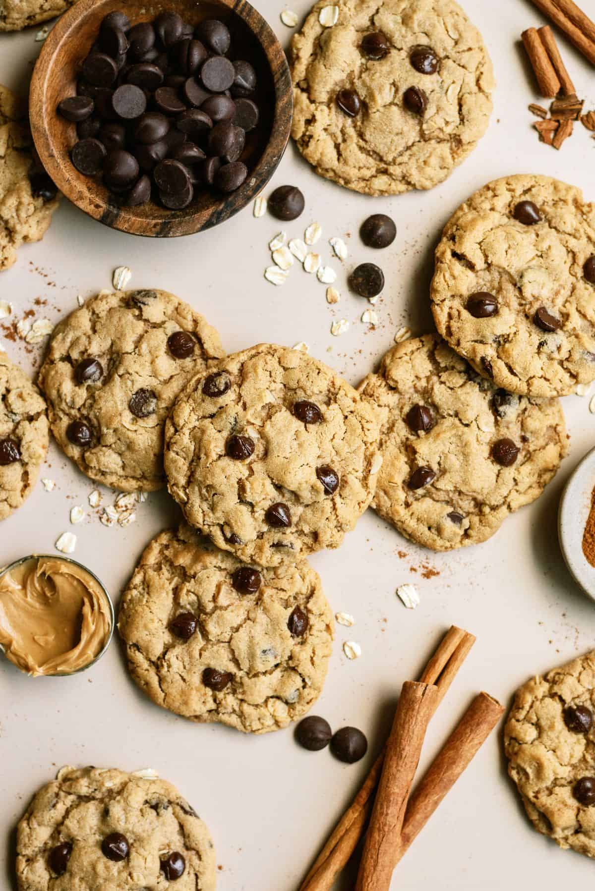 Oatmeal Chocolate Chip Peanut Butter Cookies on a counter with a small bowl of chocolate chips