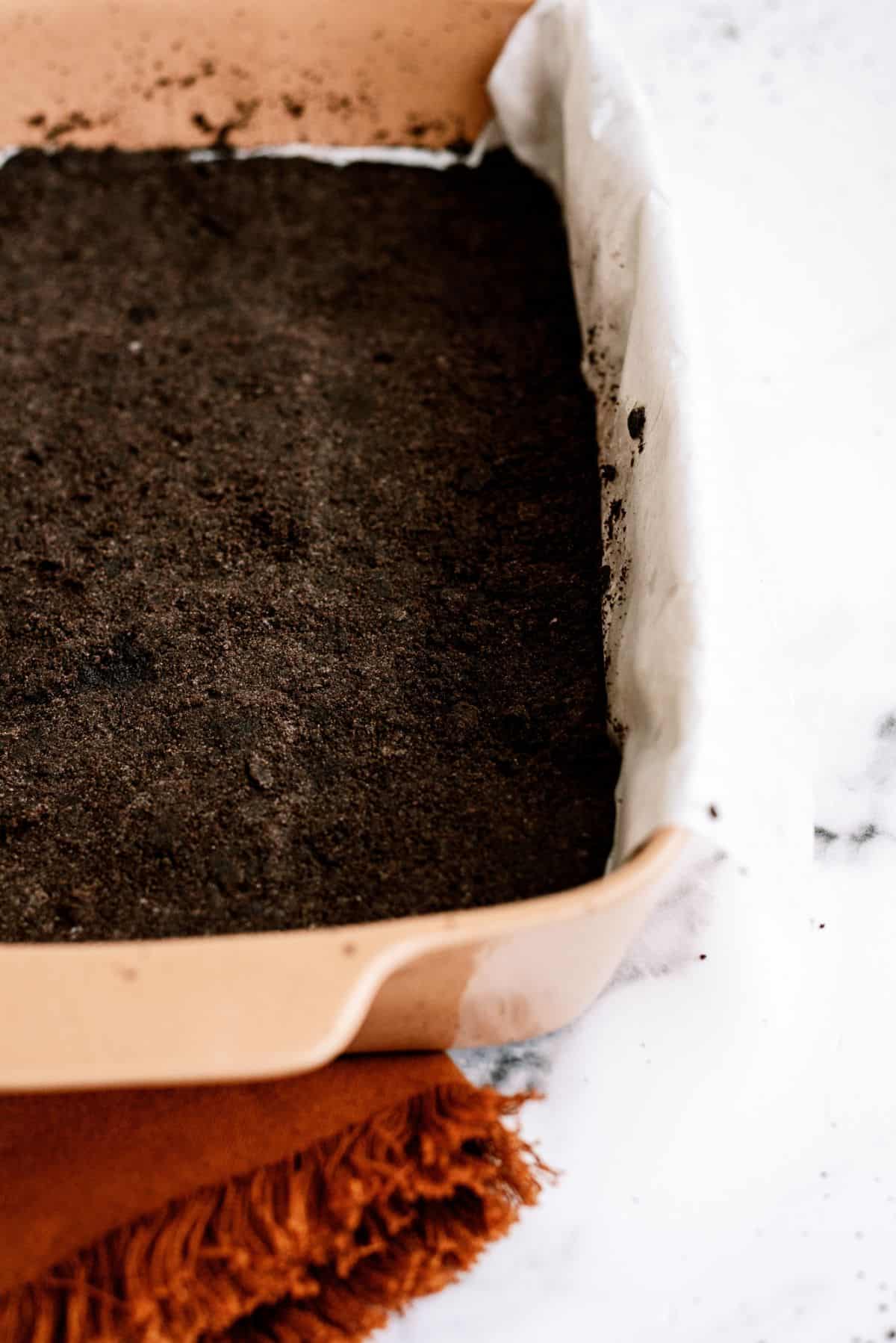 Oreo crust pressed into baking pan