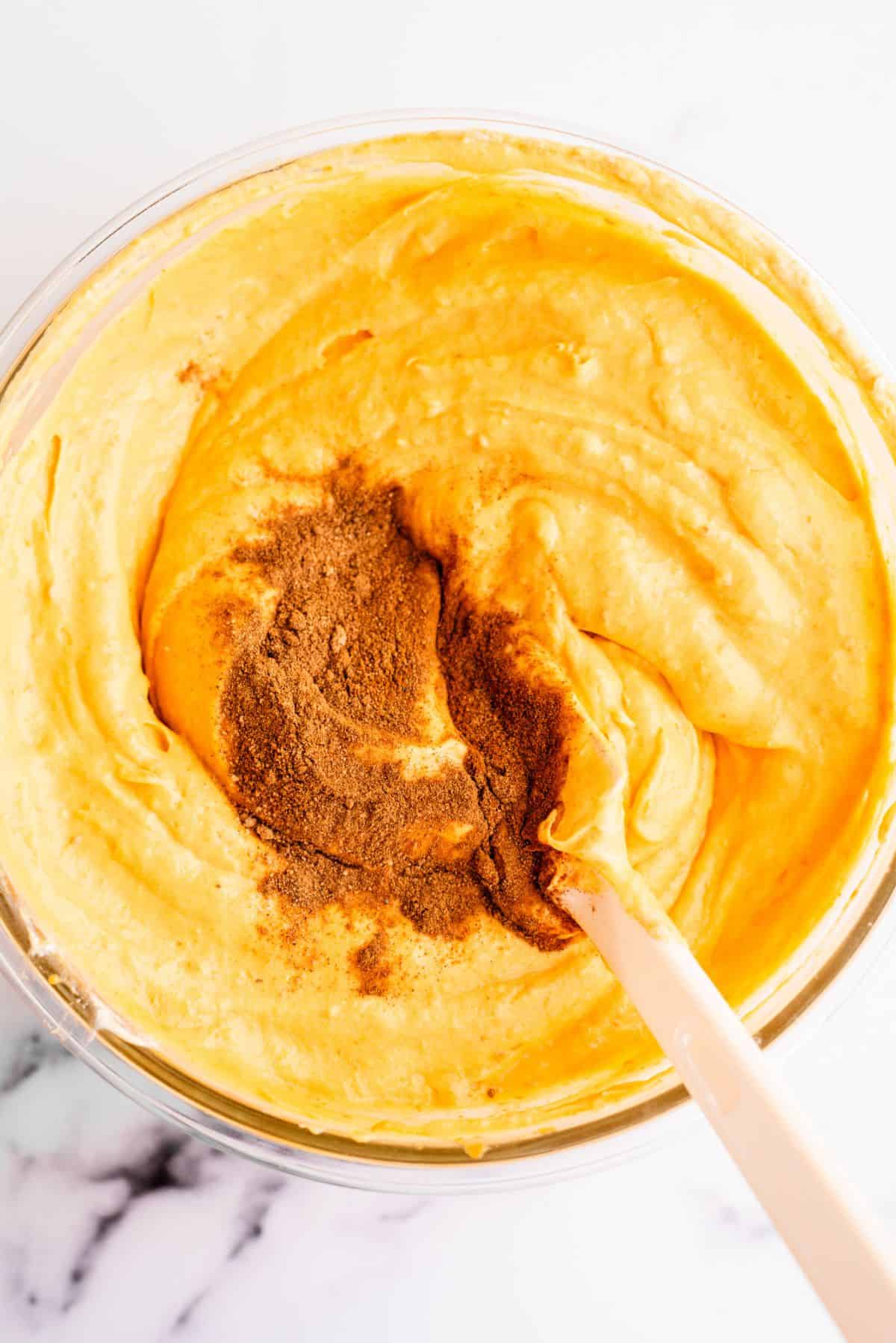 Pumpkin mixture in a bowl with spices on top