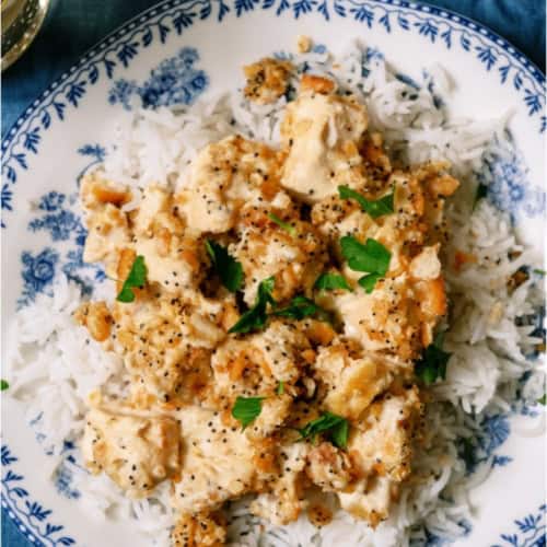 A plate of Poppy Seed Chicken Casserole served over rice.