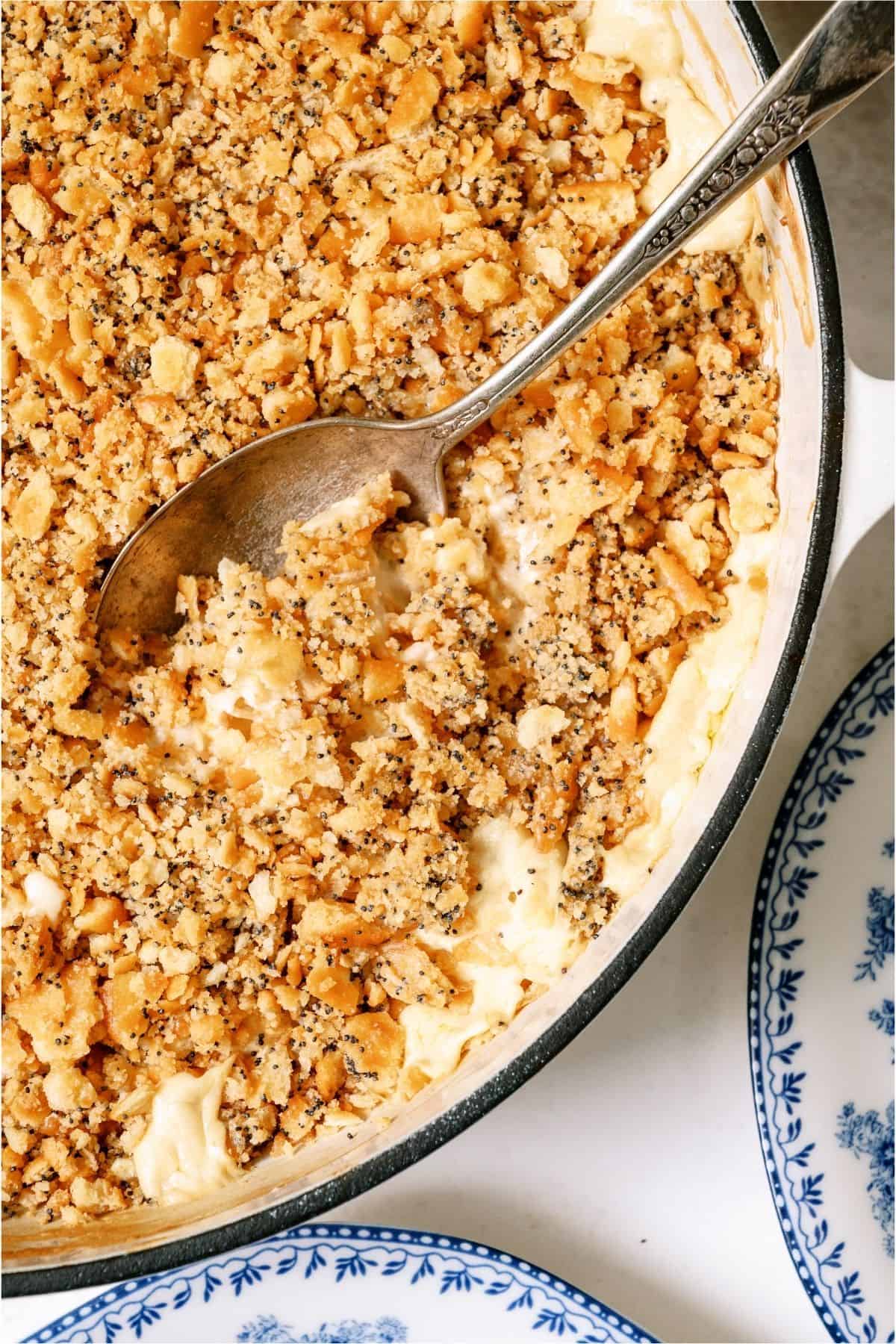 A spoon scooping out a serving of Poppy Seed Chicken Casserole.