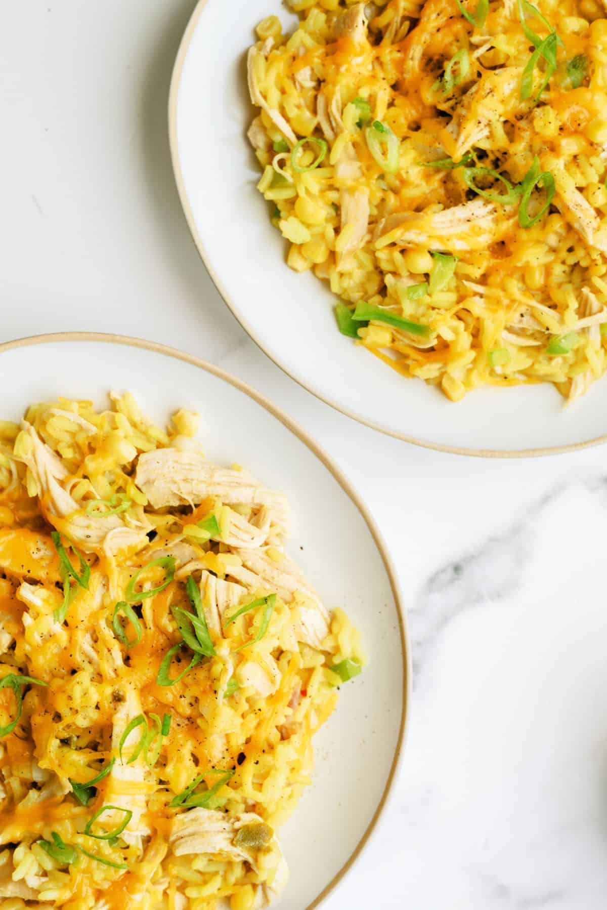 Two plates of Slow Cooker Cheesy Chicken and Rice